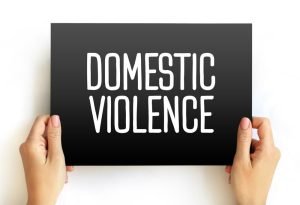 domestic violence written on a black board