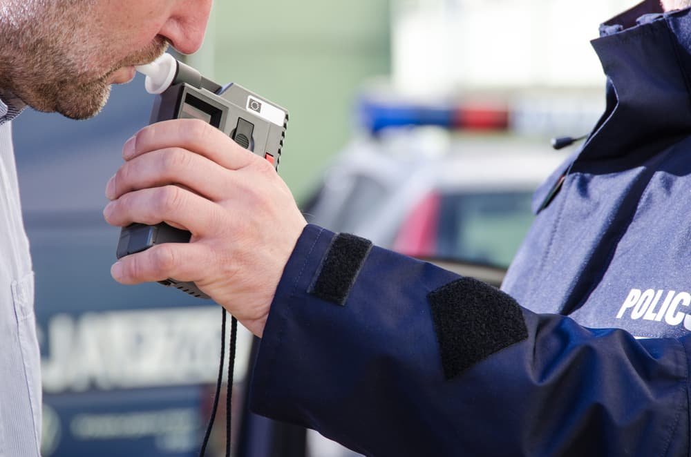 A photo depicting a police officer conducting sobriety tests on a driver to determine their level of intoxication.