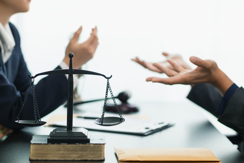 Two lawyers engaged in a debate, discussing legal strategies and arguments in a courtroom setting