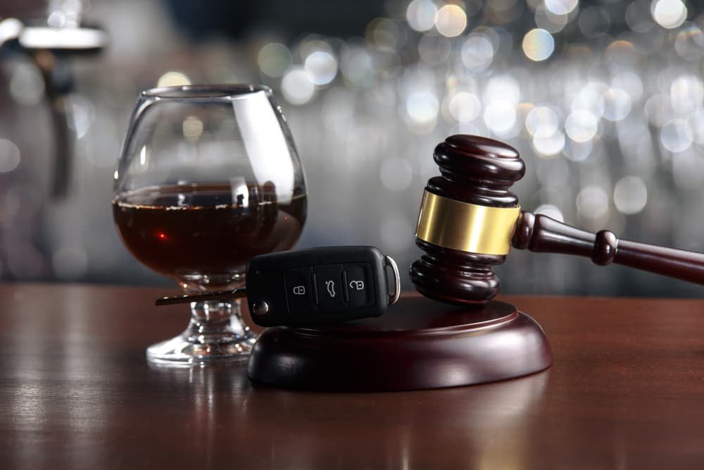 Drinking alcohol affects driving ability, with a gavel symbolizing legal consequences.